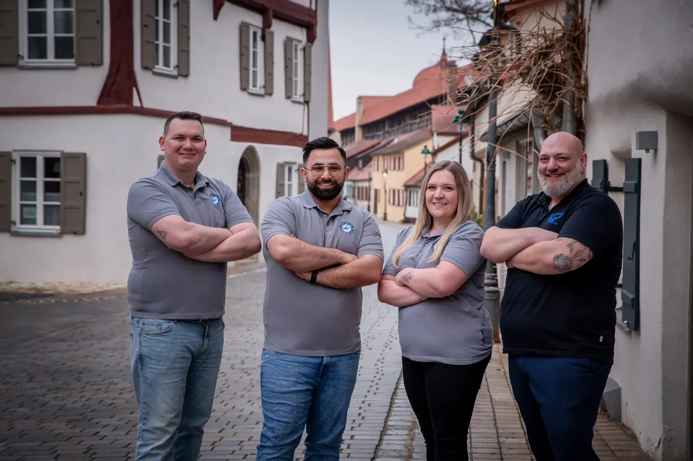 Das Team von ABW Stütz Punkt steht gemeinsam in einer Altstadtgasse in Donauwörth